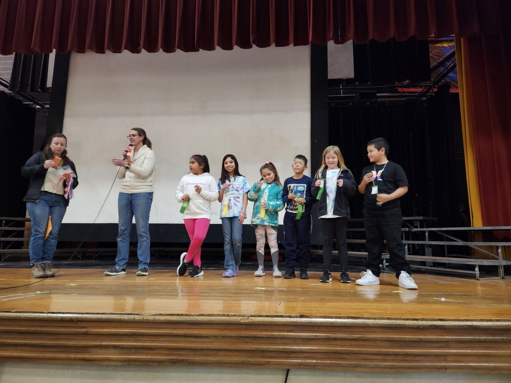 Photo of Ms. Bolton and Mrs. Jobe awarding awards to DIS student  medal winners