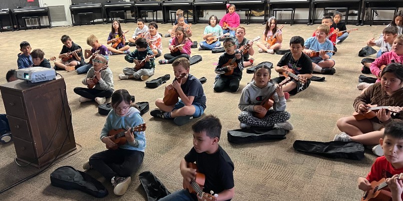 Photo of DIS students practicing on their ukuleles.